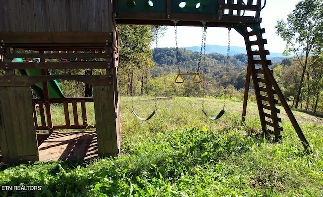 view of yard with a mountain view and a playground