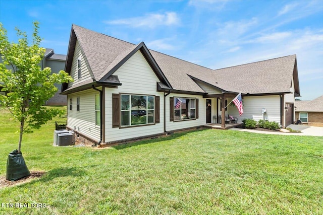 view of front of house featuring a front yard and central AC