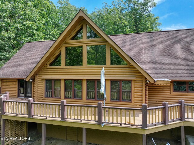 rear view of property with a wooden deck