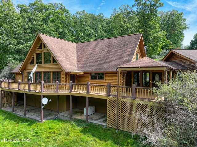 rear view of property featuring a deck