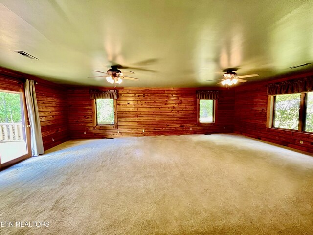 empty room featuring a wealth of natural light and ceiling fan