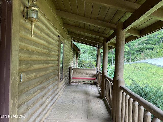 wooden terrace with a porch