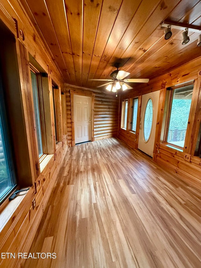 spare room with light hardwood / wood-style flooring, wood ceiling, and ceiling fan