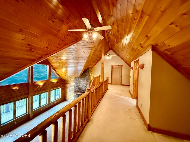 bonus room with wood ceiling, ceiling fan, and light colored carpet