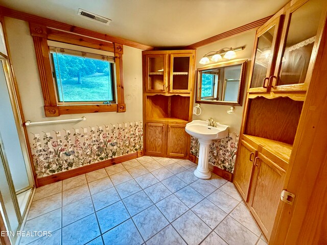 bathroom featuring an enclosed shower and tile patterned floors