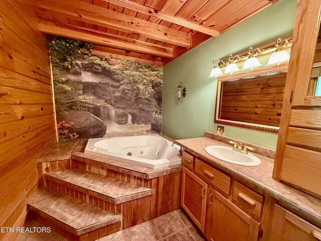 bathroom with beamed ceiling, vanity, wood ceiling, a tub, and tile patterned flooring