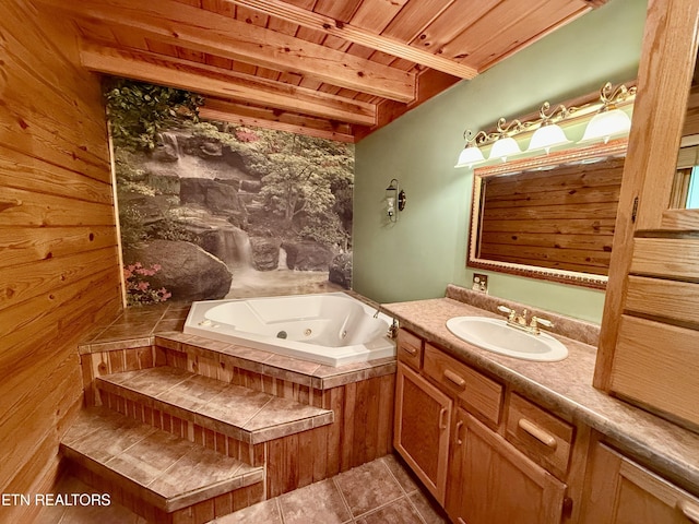 full bath with a tub with jets, vanity, wooden ceiling, tile patterned flooring, and beam ceiling