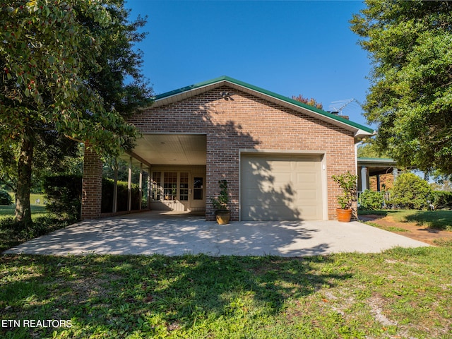 view of side of property featuring a yard and a garage