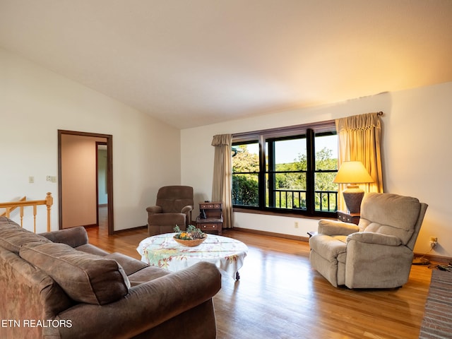 living room featuring light wood-type flooring and lofted ceiling