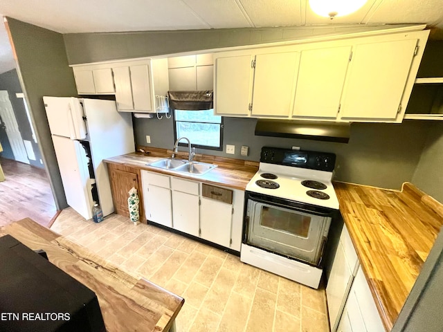 kitchen with sink, range with electric stovetop, white cabinets, and white refrigerator