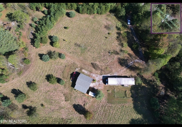 birds eye view of property with a rural view