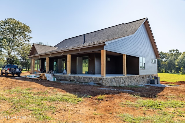 rear view of property with central AC