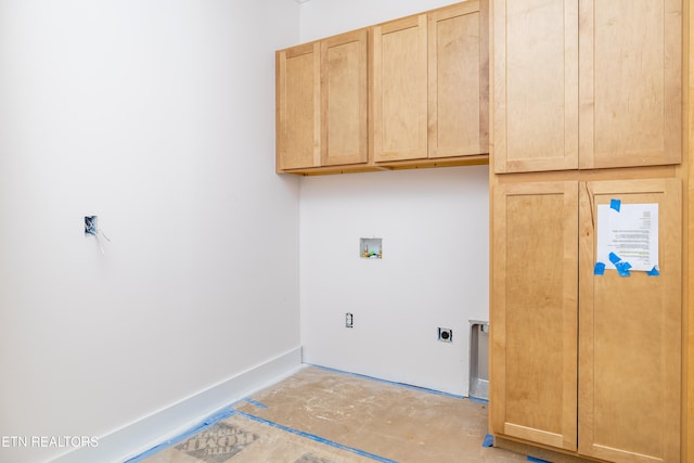 clothes washing area with hookup for an electric dryer, cabinets, and washer hookup