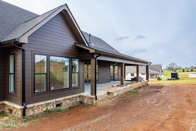 view of side of home featuring a patio area