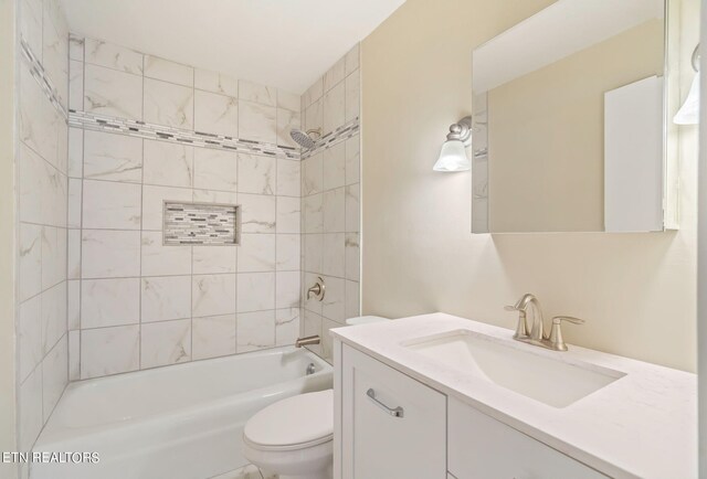 full bathroom with vanity, toilet, and tiled shower / bath