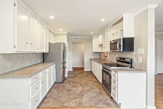 kitchen with white cabinets, ornamental molding, appliances with stainless steel finishes, and sink