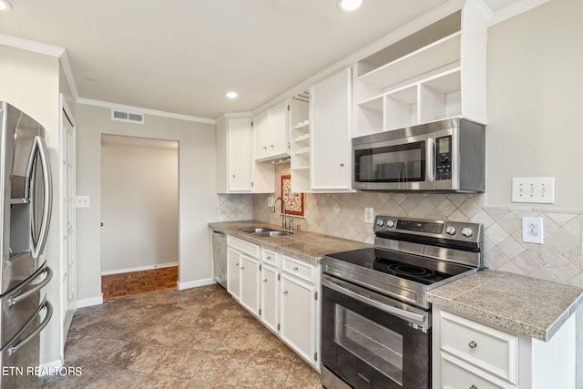 kitchen featuring appliances with stainless steel finishes, white cabinetry, and sink