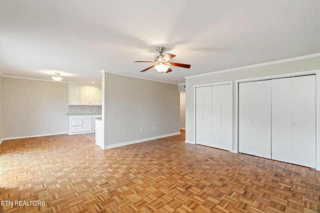 interior space featuring ceiling fan, ornamental molding, and light parquet flooring