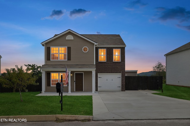 front of property with a garage and a lawn