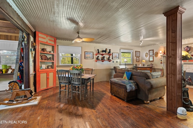 dining room with a ceiling fan, hardwood / wood-style flooring, and ornate columns