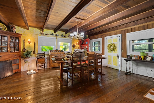 dining area with wood ceiling, a notable chandelier, hardwood / wood-style flooring, and beamed ceiling