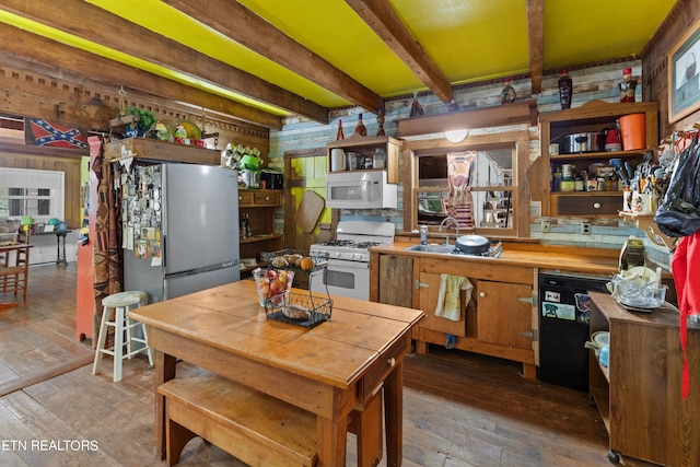 kitchen featuring a sink, hardwood / wood-style flooring, open shelves, and white appliances