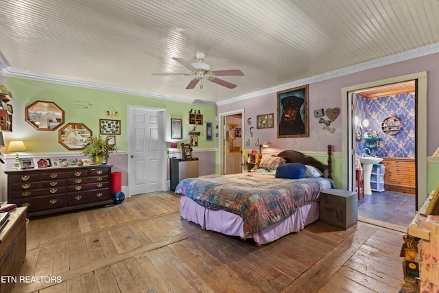 bedroom featuring a wainscoted wall, crown molding, ceiling fan, and wood-type flooring