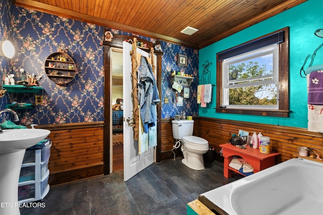 bathroom with a wainscoted wall, ornamental molding, wallpapered walls, and wooden ceiling