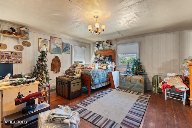 bedroom featuring a notable chandelier and hardwood / wood-style floors