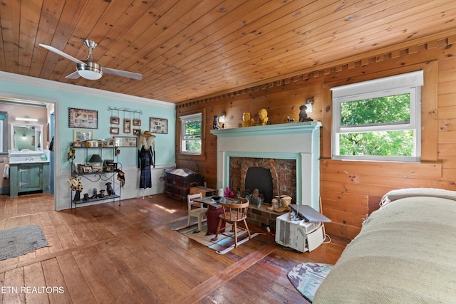 living room with hardwood / wood-style floors, a ceiling fan, wood ceiling, and a healthy amount of sunlight