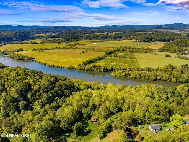 aerial view with a forest view and a water view