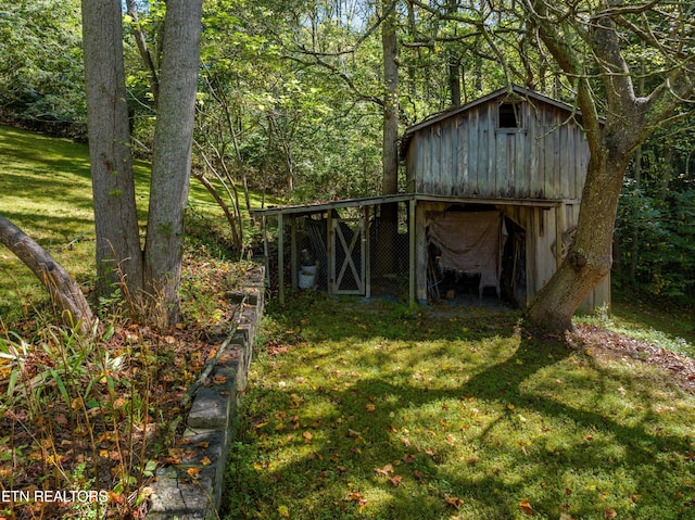 view of outbuilding with an outdoor structure and a view of trees
