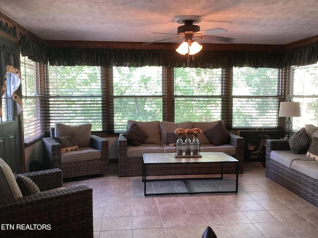 tiled living room with a textured ceiling and ceiling fan