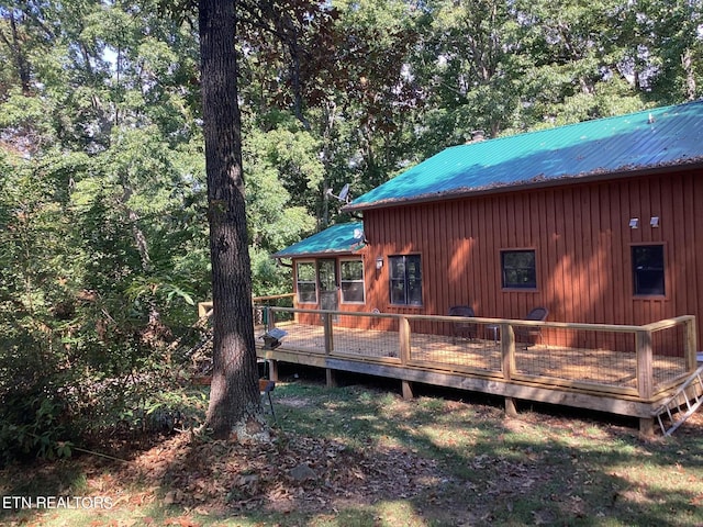 exterior space with metal roof and a deck