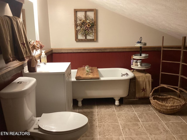 bathroom with a tub to relax in, a textured ceiling, wooden walls, and toilet