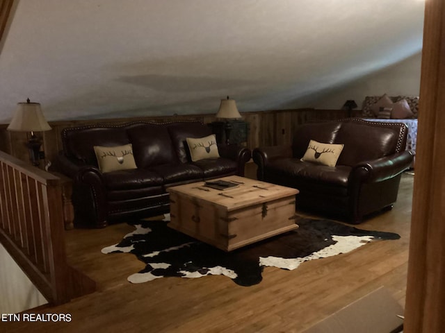 living room featuring lofted ceiling and wood finished floors