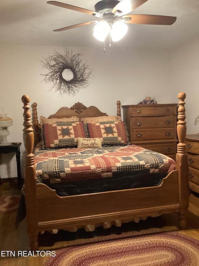 bedroom with ceiling fan and hardwood / wood-style flooring