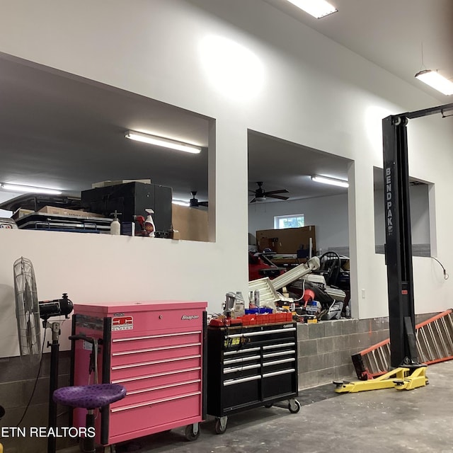 garage with a workshop area and ceiling fan