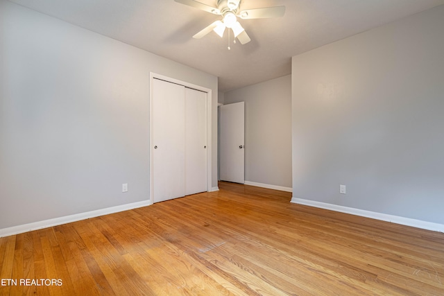 unfurnished bedroom featuring ceiling fan, a closet, and light hardwood / wood-style floors