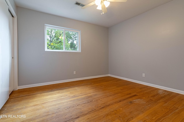 spare room featuring light hardwood / wood-style floors and ceiling fan