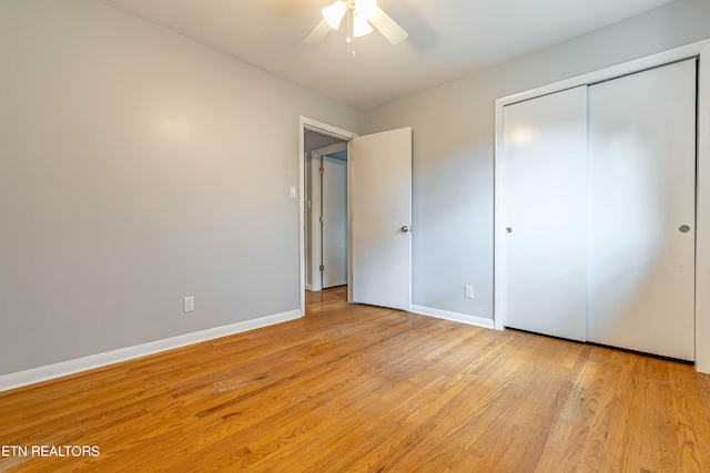 unfurnished bedroom featuring light wood-type flooring, ceiling fan, and a closet