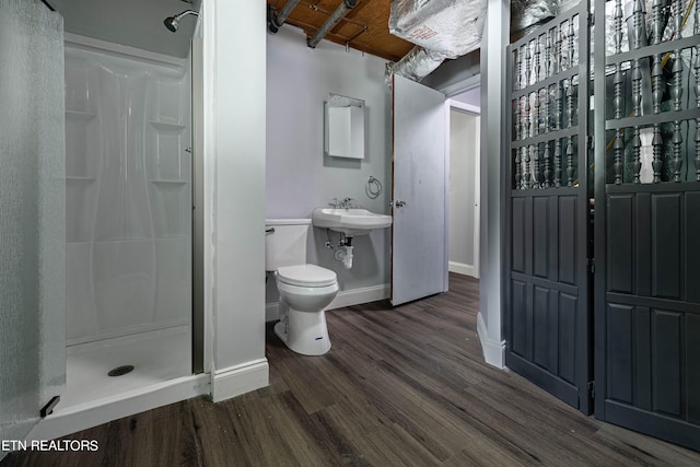 bathroom with wood-type flooring, walk in shower, beam ceiling, and toilet