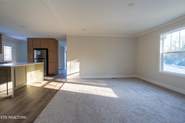 unfurnished living room featuring ornamental molding