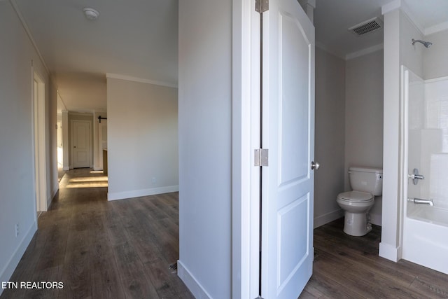 hallway with crown molding and dark hardwood / wood-style floors