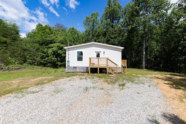 105 Highland Ave, Clinton, TN 37716 - manufactured / mobile home with a deck, crawl space, a forest view, and driveway