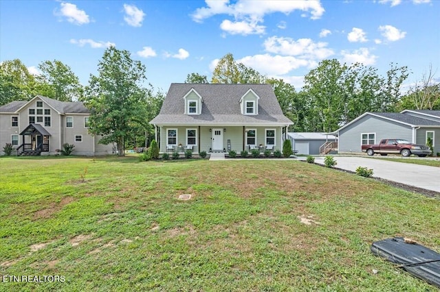 cape cod-style house with a front yard, a porch, and a garage