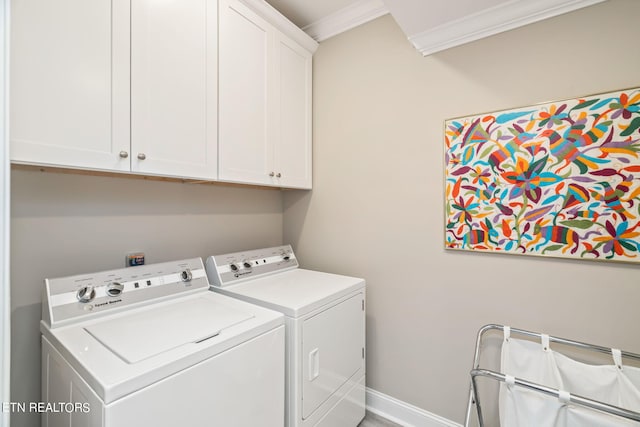 clothes washing area with ornamental molding, cabinets, and independent washer and dryer