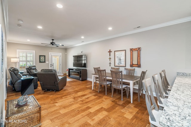 interior space with ceiling fan, light wood-type flooring, and crown molding