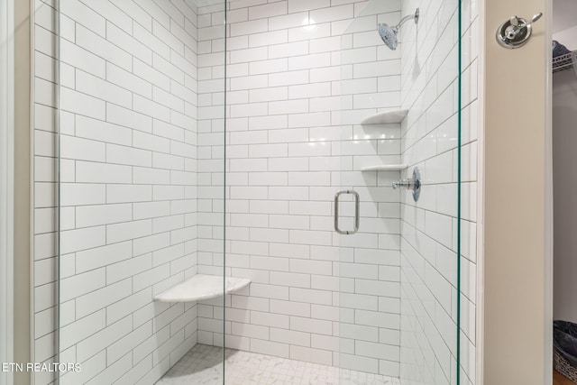 bathroom with a shower with shower door