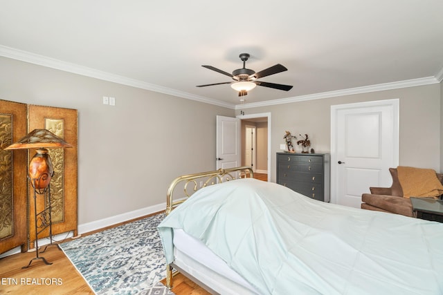 bedroom with ceiling fan, hardwood / wood-style floors, and crown molding